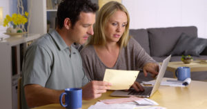 Couple reviewing home prices and housing market reports